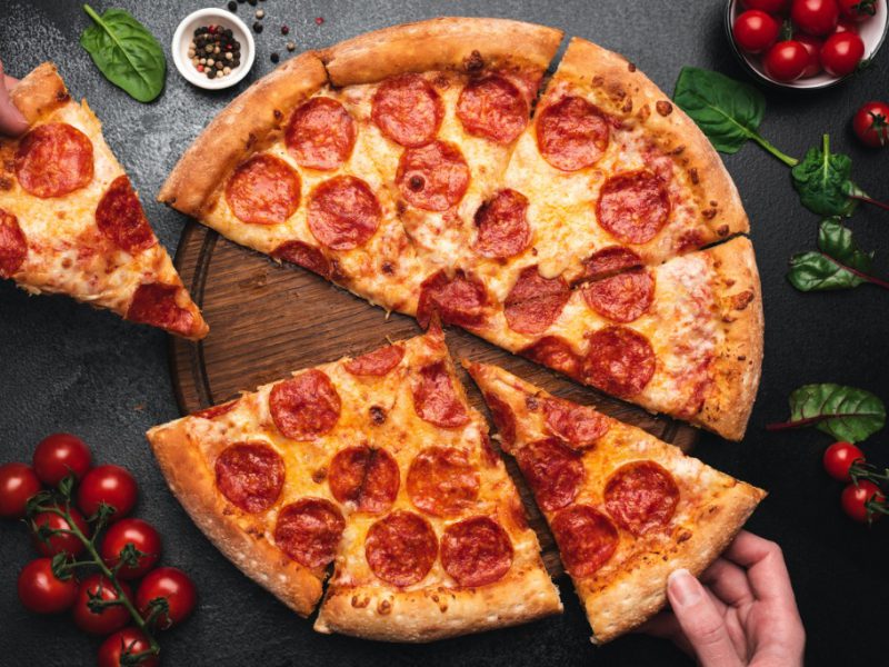 picking-slice-of-pepperoni-pizza-picture-id1133727757